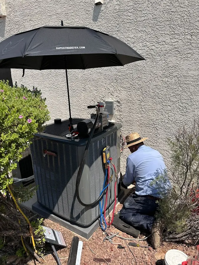 HVAC technician performing outdoor AC maintenance in Grosse Pointe